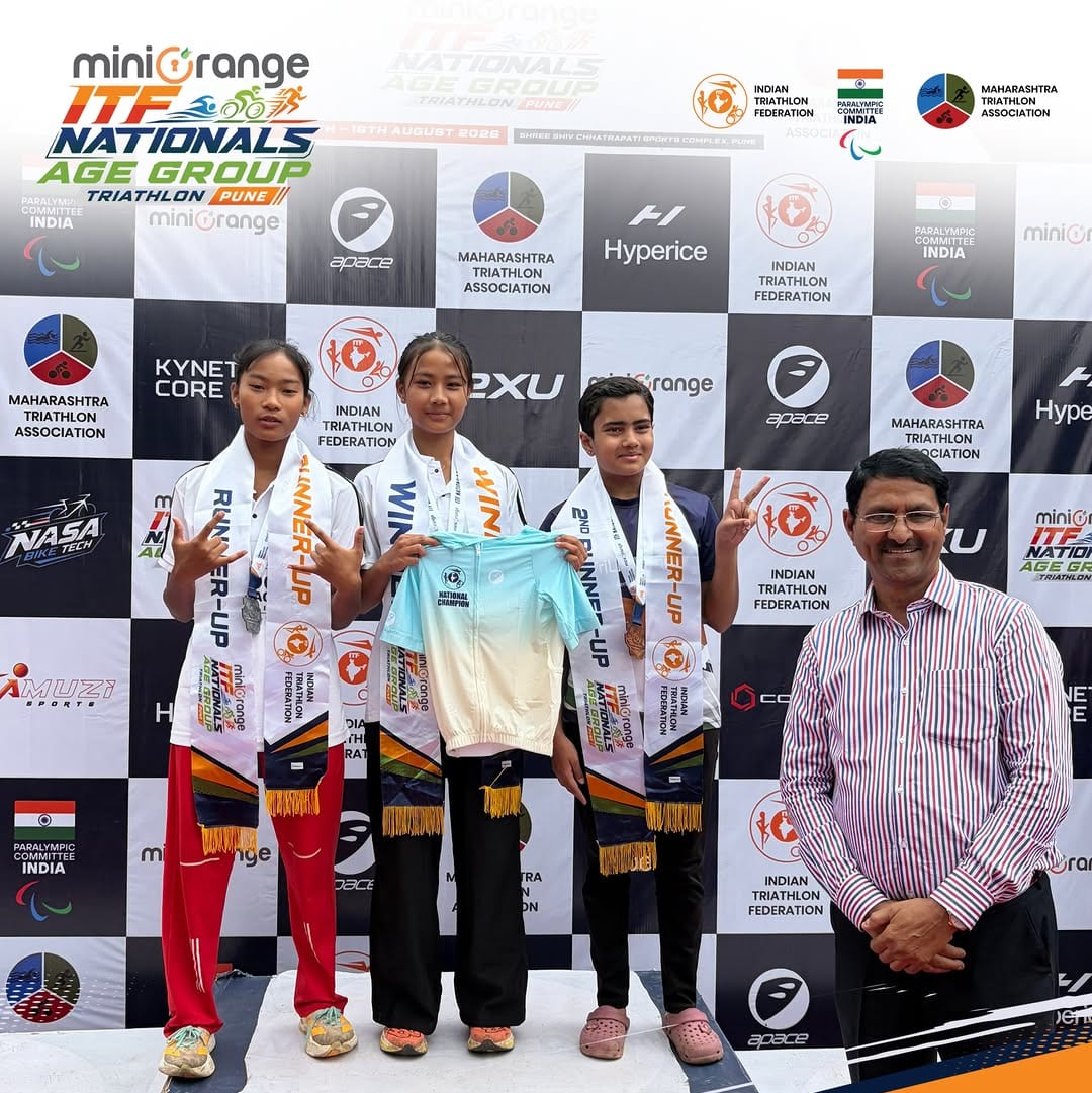 Youth triathletes on the podium with an ITF official at the Nationals Age-Group championship in Pune